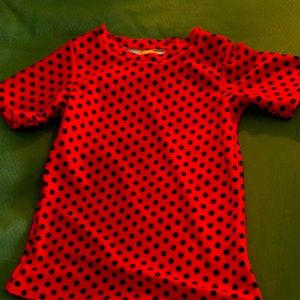 Handmade girls pajama top. Polyester fabric. Black polka dot on red background.